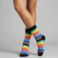 Colorful striped socks worn by a person on a gray background