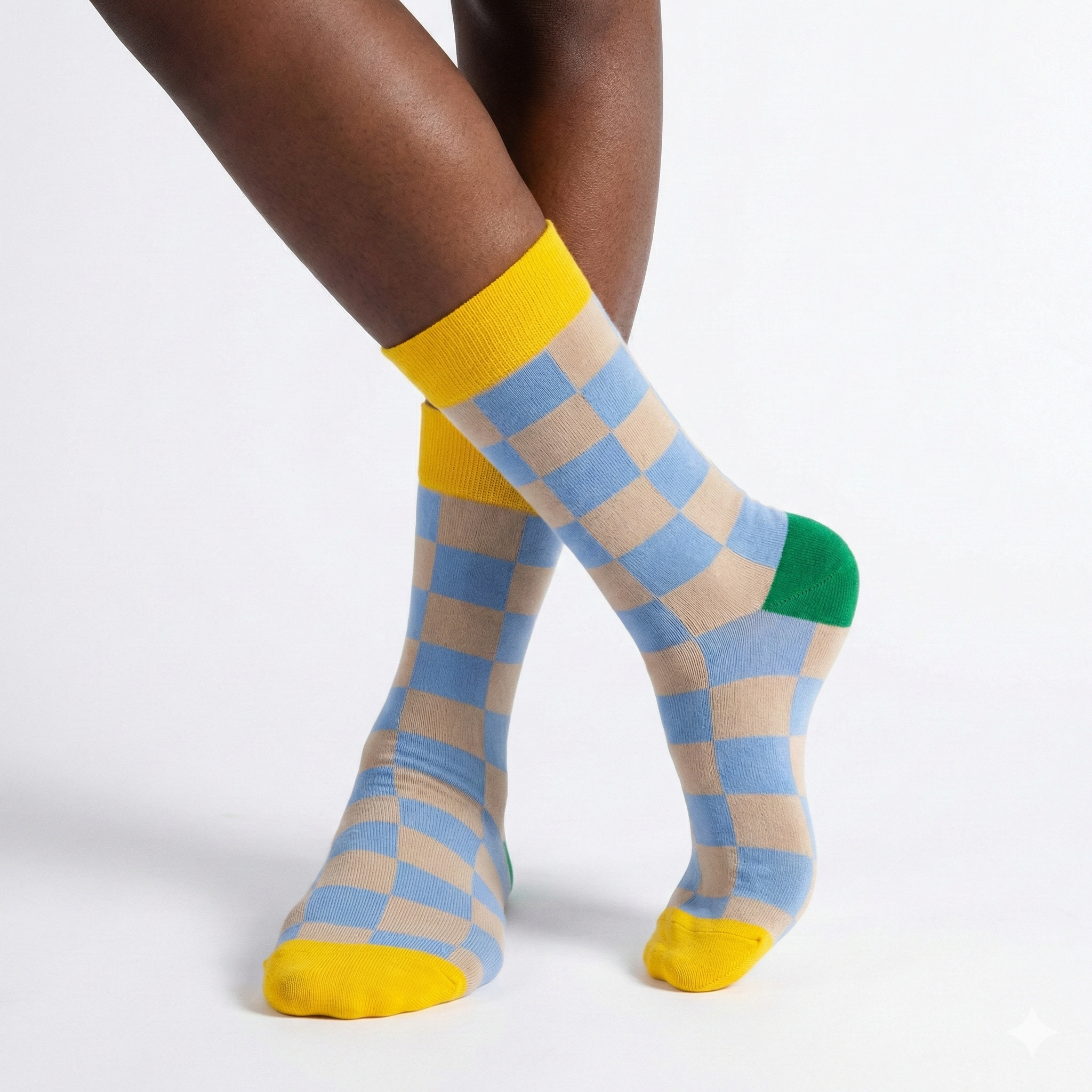 Checkered socks with yellow accents worn by a person on a white background