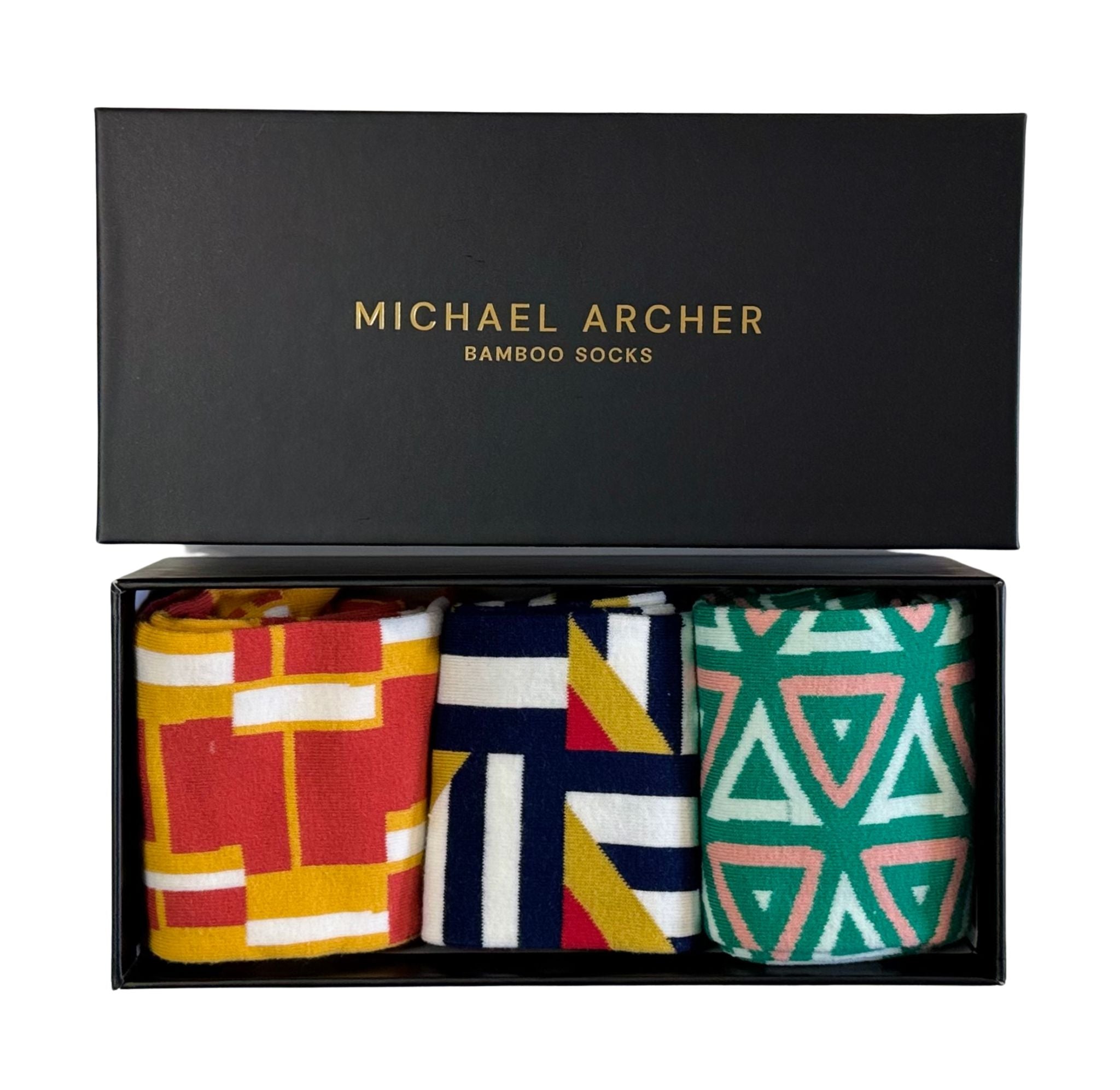 Three pairs of patterned socks in a black 'Michael Archer' box.