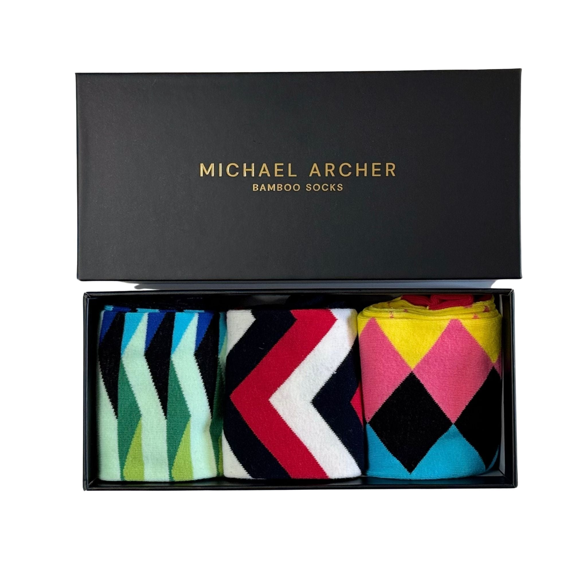 Box of Michael Archer socks with colorful patterns on a white background