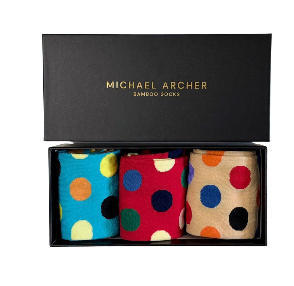 Three pairs of polka dot socks in a black box with 'Michael Archer' branding.
