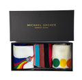 Box of Michael Archer bamboo socks with colorful designs on a white background