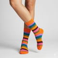 Colorful striped socks worn by a person on a light gray background
